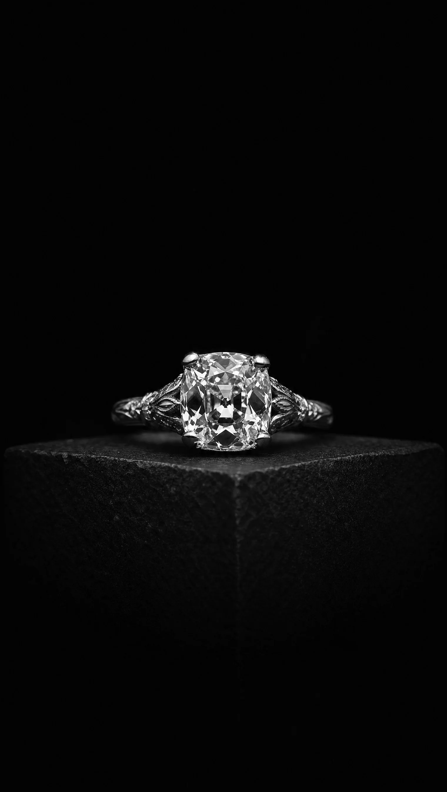 Old-mine cushion-cut diamond solitaire ring in a vintage platinum setting